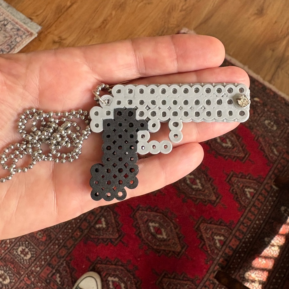 Gray and Black Beaded Gun Pendant Necklace made with fuse beads.